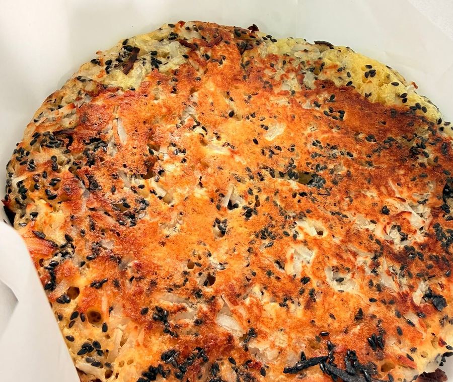 A large thin crepe flecked with black sesame, browned at the edges. Photograph posted by Hasina's Burmese Kitchen.