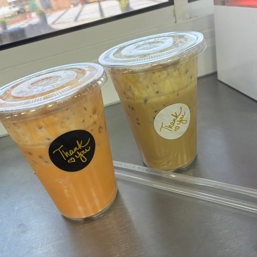 Two iced milk teas in lidded cups on the counter. Photograph posted by Hasina's Burmese Kitchen.
