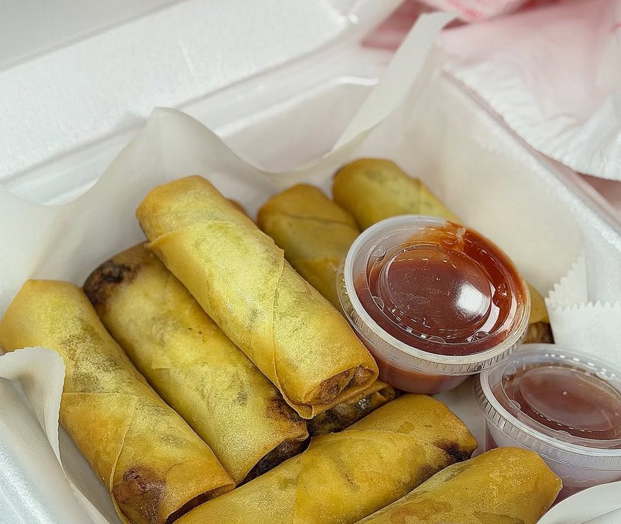 Fried rolls in a takeout box with two cups of sauce. Photograph posted by Hasina's Burmese Kitchen.